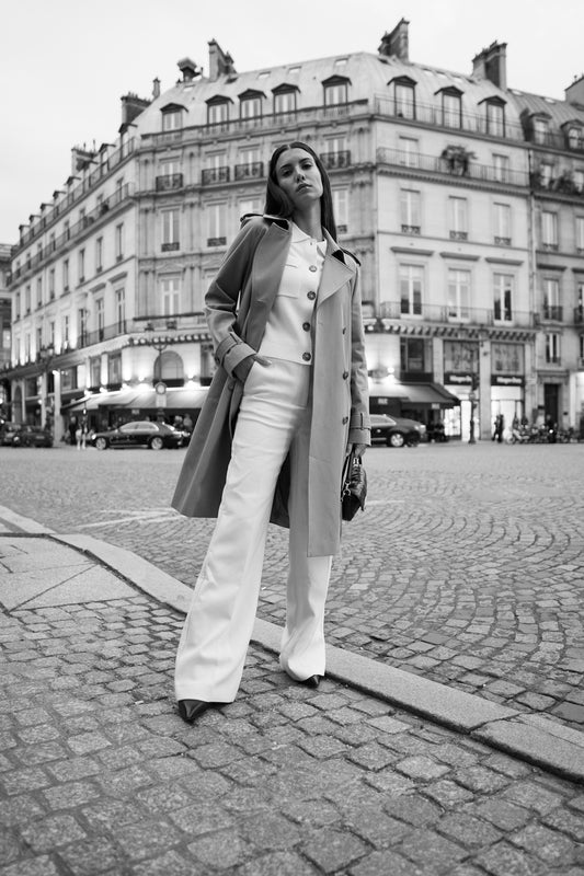 A woman standing on a brick road in front of a building